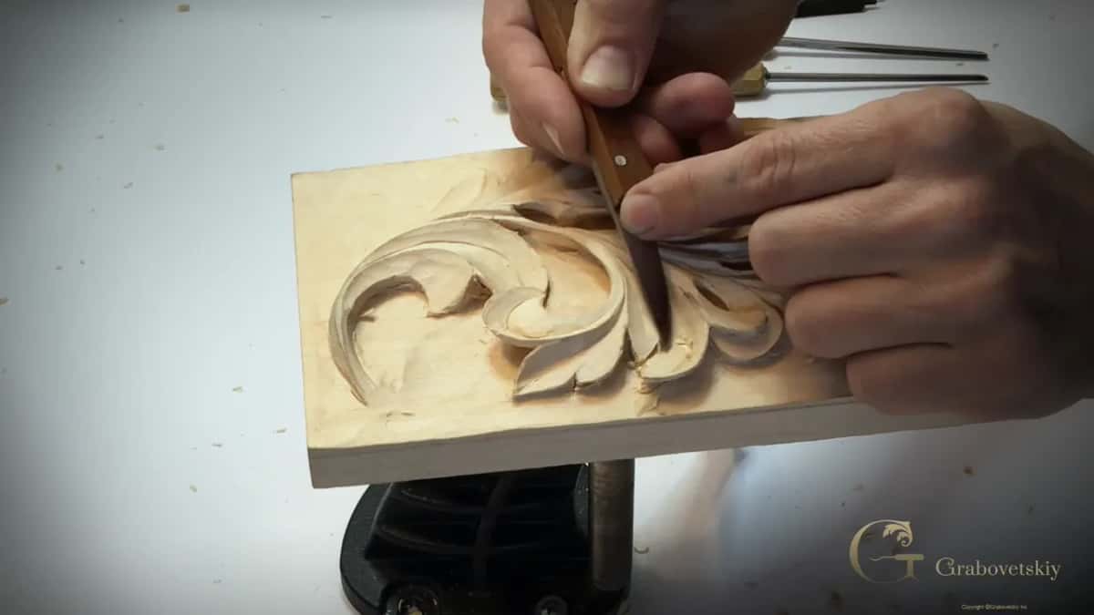 Dark handle pushed down into the middle of the leaf, steel shafts lined up behind the panel