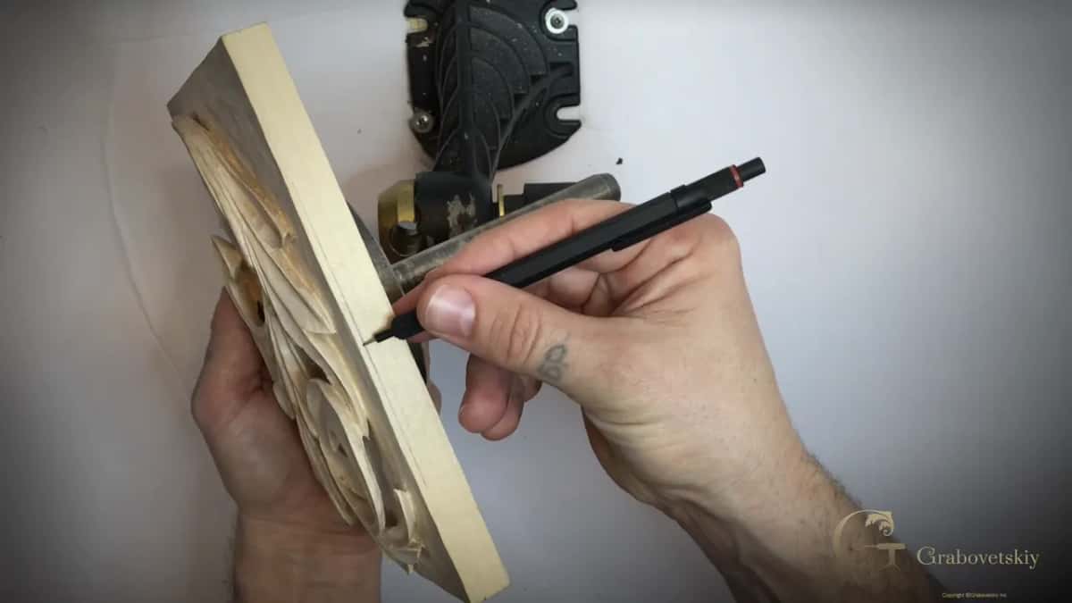 Pencil riding the board edge while a finger acts as the fence