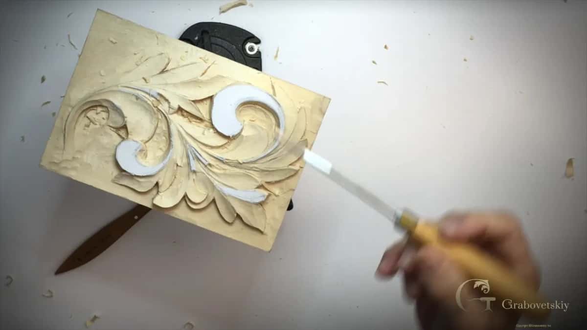 Yellow handle lifted off the panel, a knife lying on the table at left