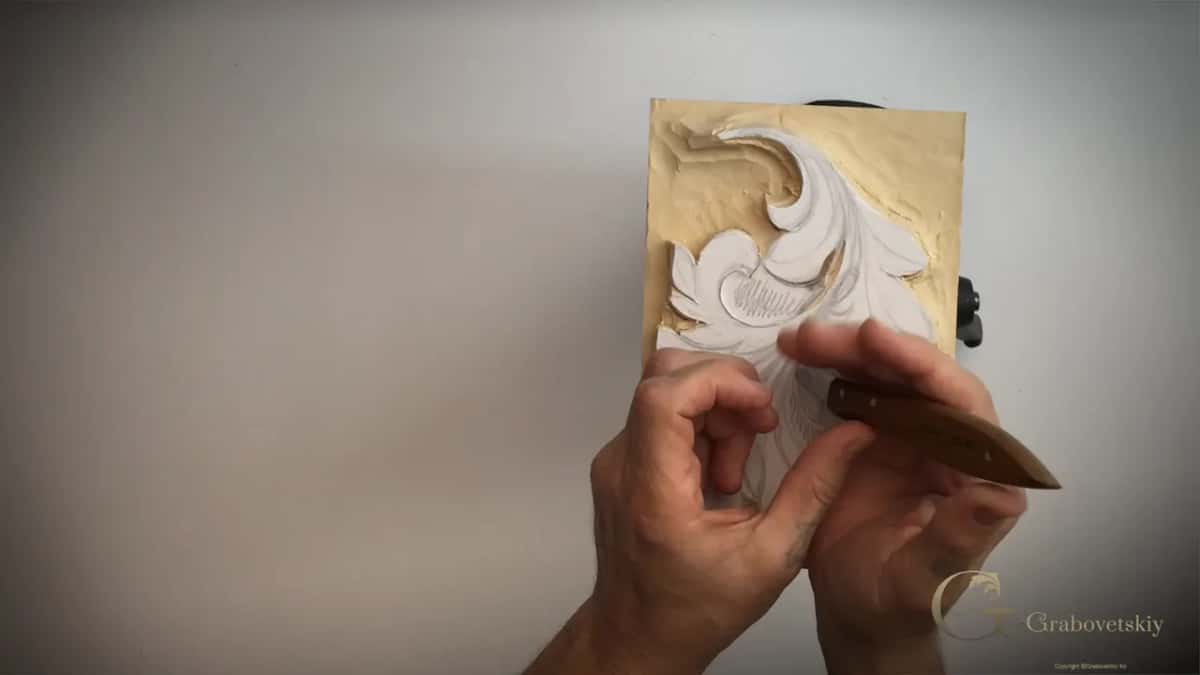 Panel turned on end, two hands working one knife