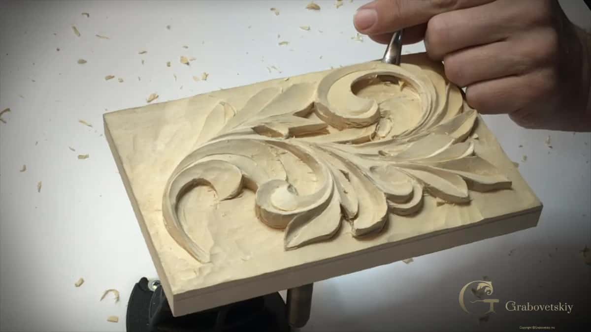 Hand coming down from above with a gouge at the top curl of the panel