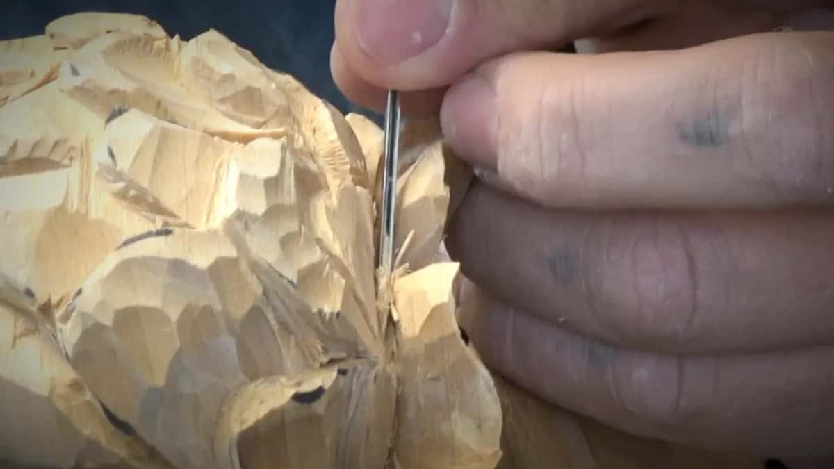 Thin shaft pinched in the fingers, pushed down into a join.