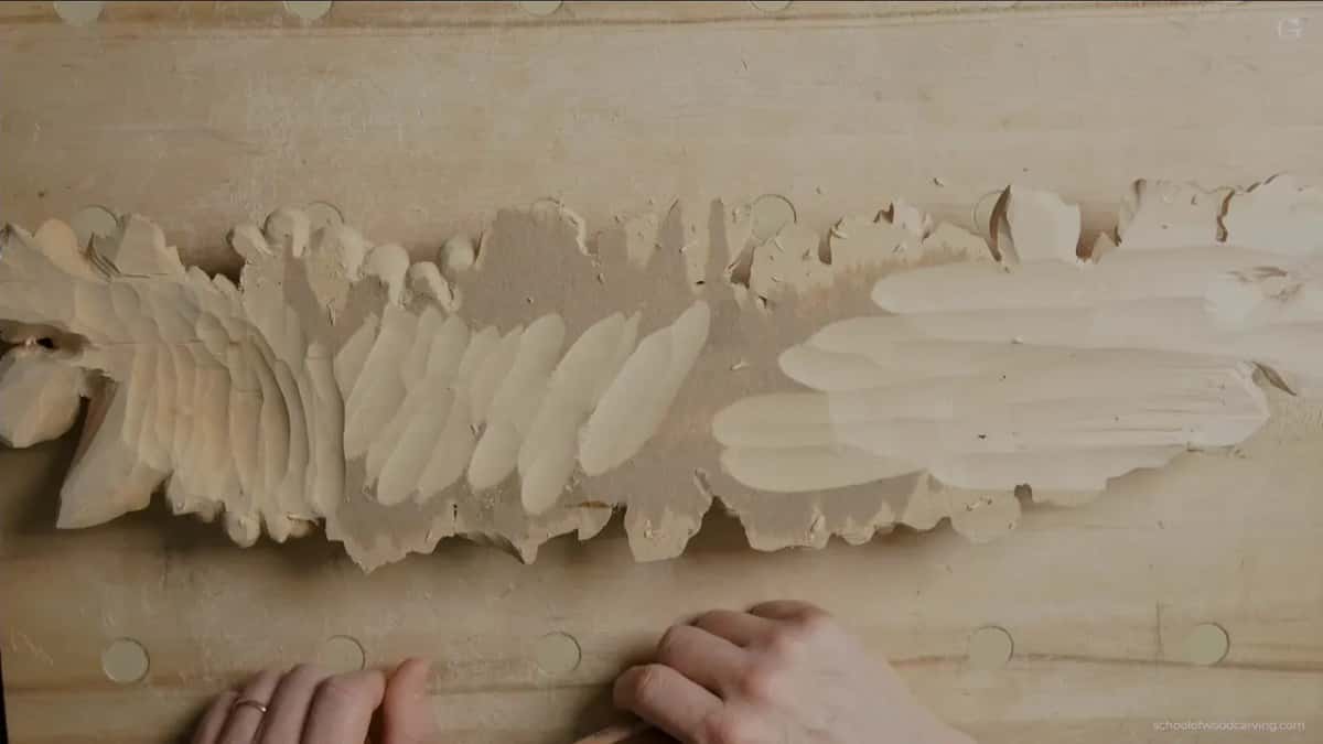 Two hands holding the turned onlay near its lower side