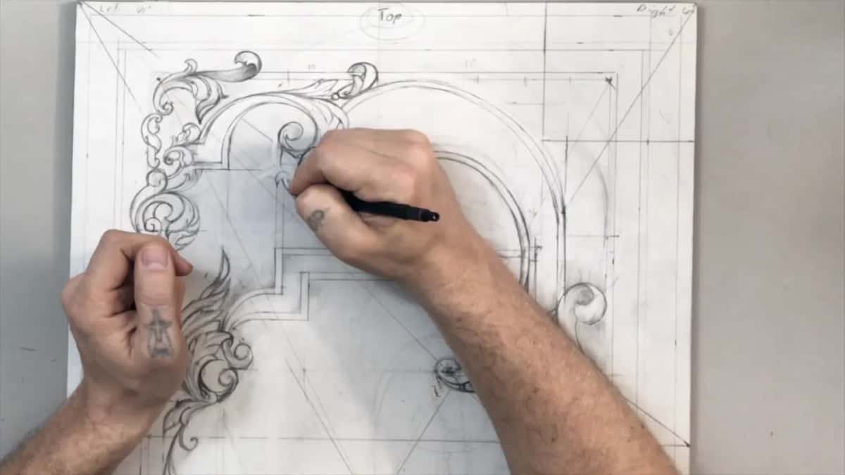 Right hand drawing a curl under the circled word Top while the left one rests on the sheet