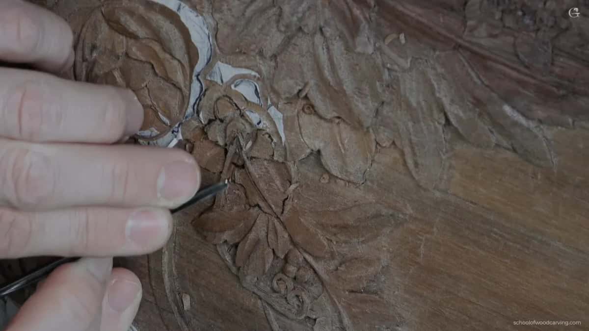 Fingers guide a thin veiner along a petal