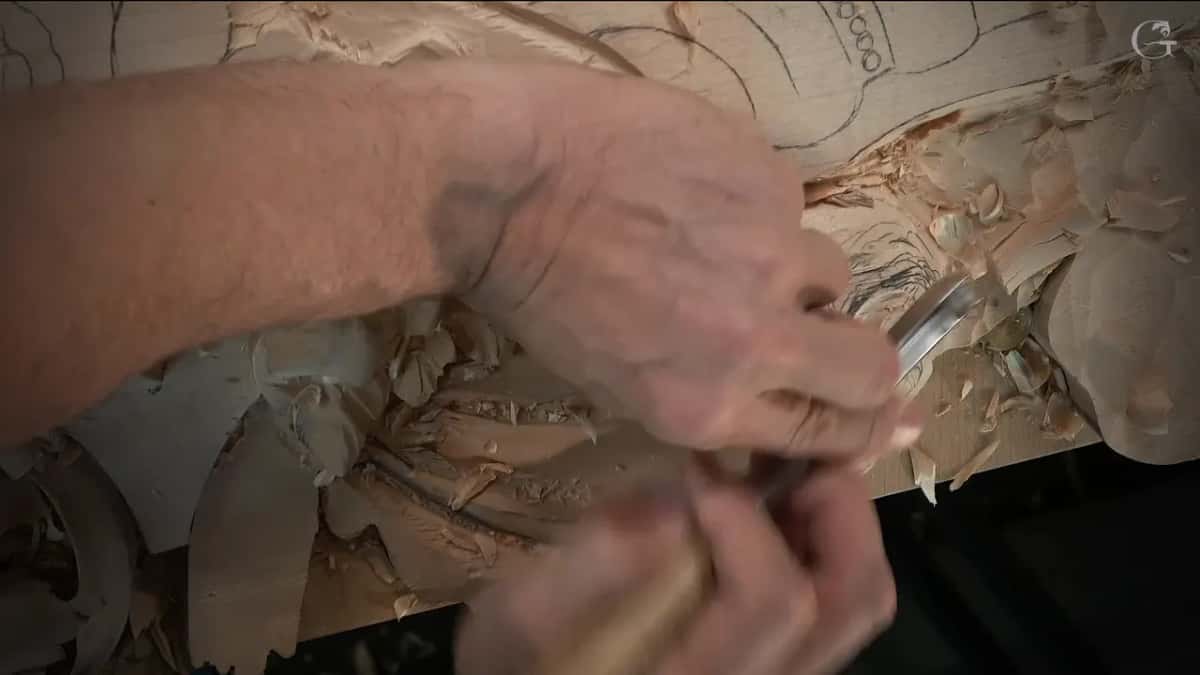 Two hands on one gouge at the dome's edge