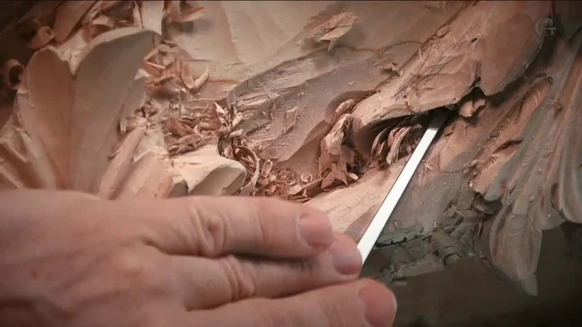 Straight blade reaching deep into a slot while the other hand steadies the board
