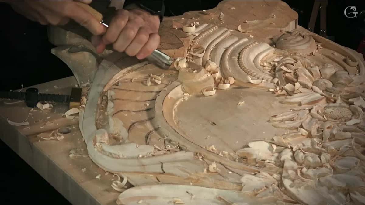 Two hands steering a gouge