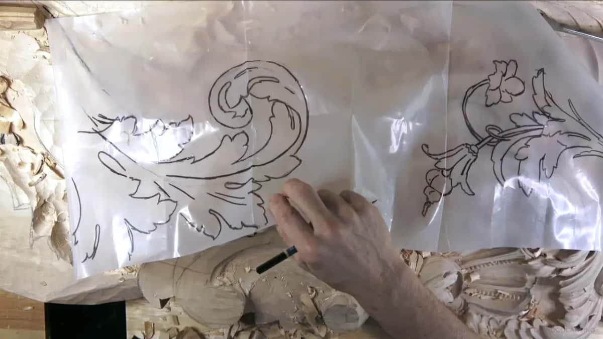 Laid flat on the board, the plastic drawing, with a pen held over it.