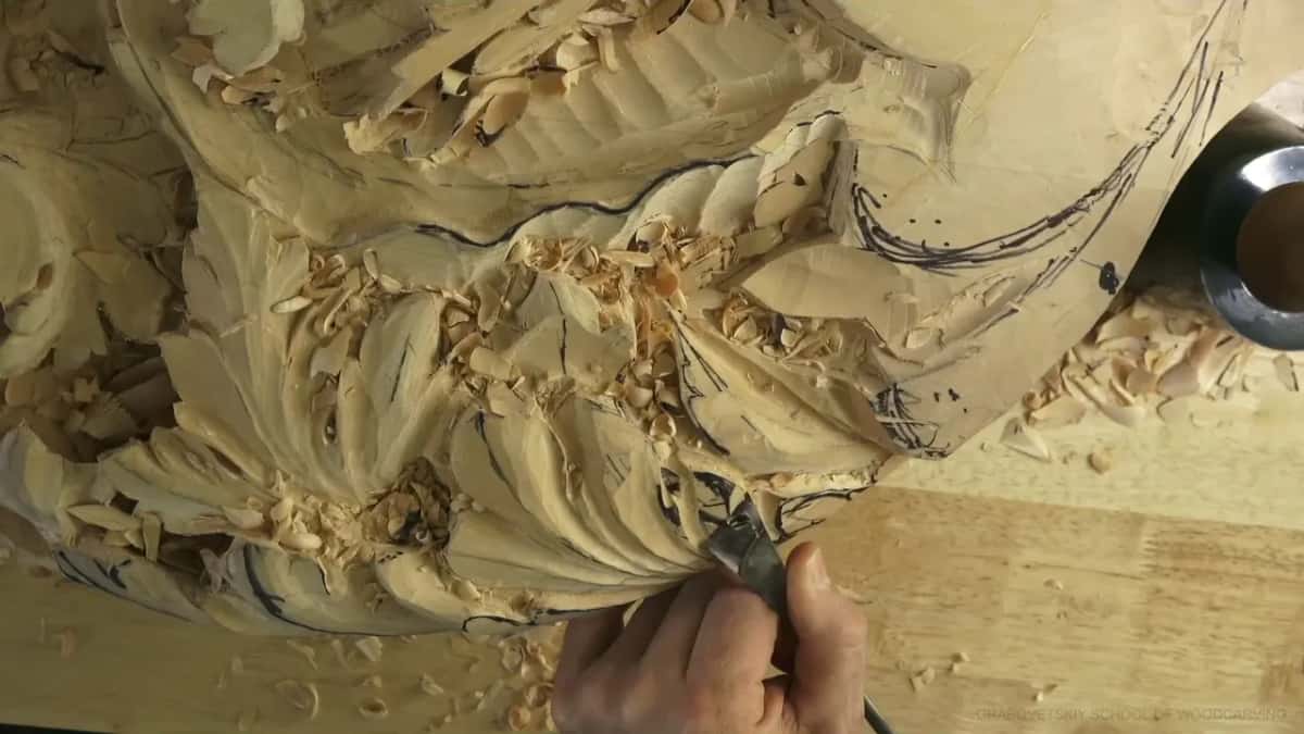 Fingers pinch a short tool at the bottom right corner.