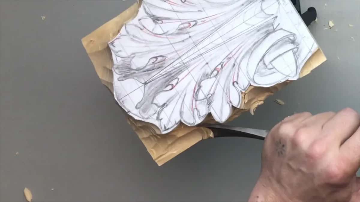 Gouge at the bottom edge, with the waste under the paper leaf already gone