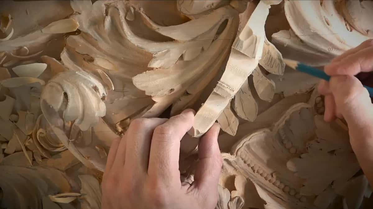 Rough leaf piece held up against the carved acanthus panel it will fill