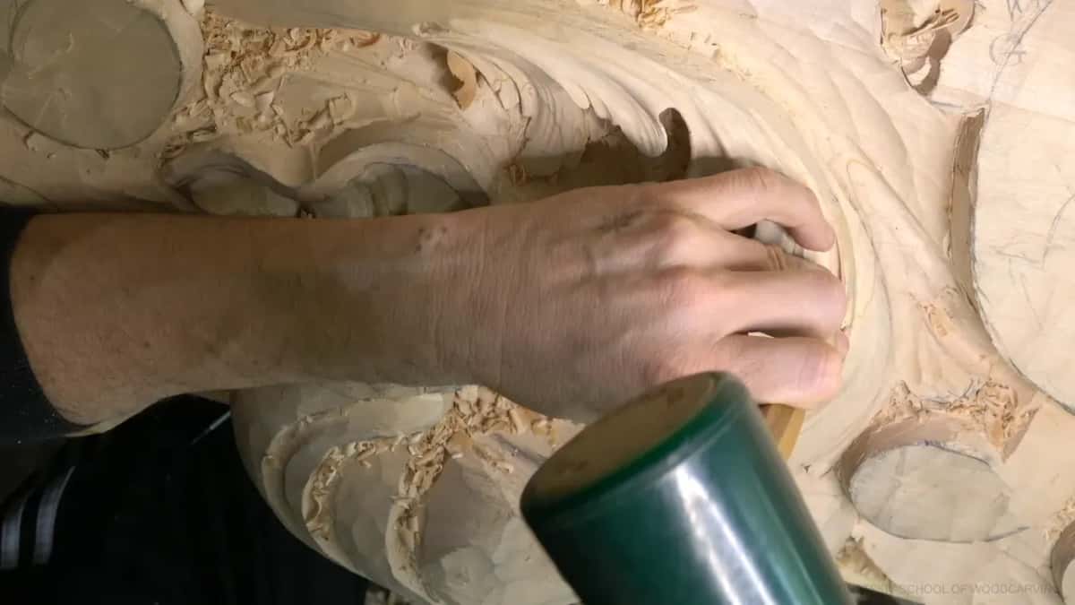 Green rubber mallet resting by the work.