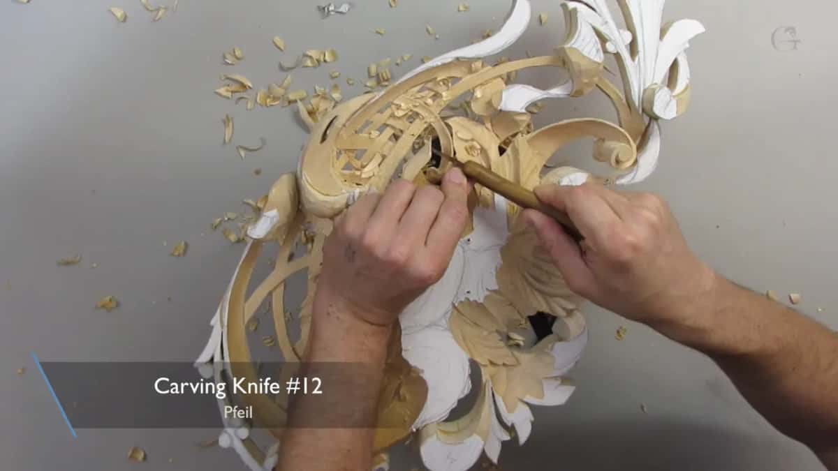 With both hands I work a carving knife along the edge of the lattice, a caption naming it number 12