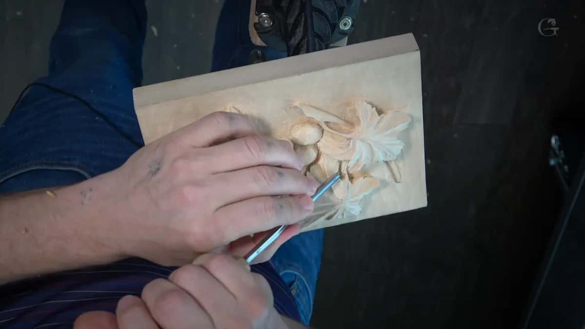 Both hands on a slim tool at the right leaf