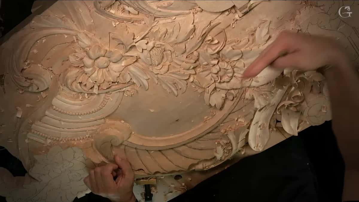 Finger over carved flowers