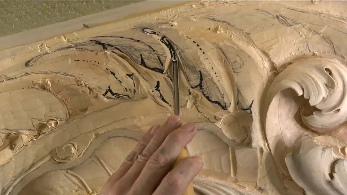 An upright gouge, inked strokes behind it.