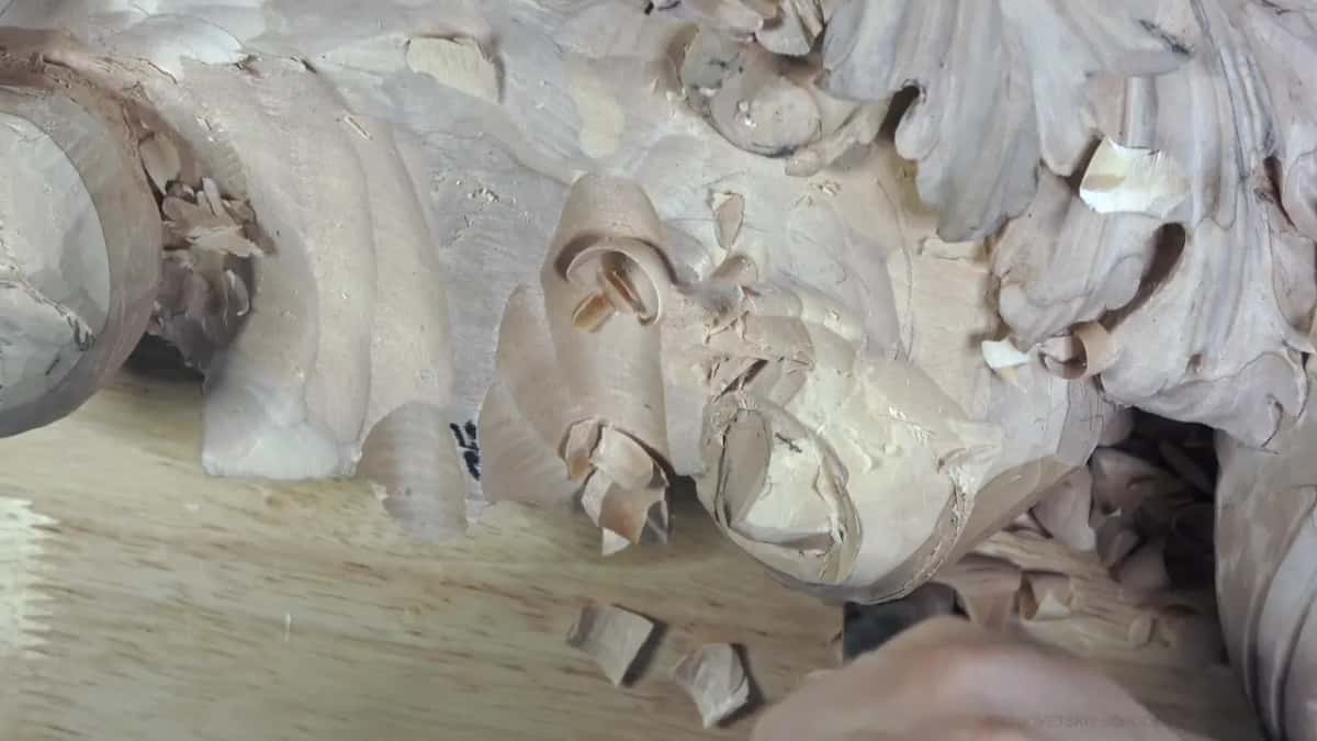 Chips sit in the turns of the spiral as it takes shape, a hand just in frame.