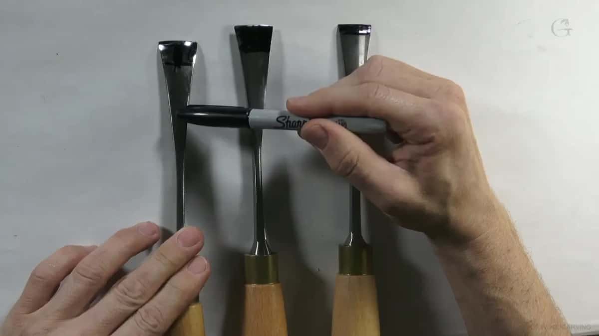 A Sharpie laid across all three blades