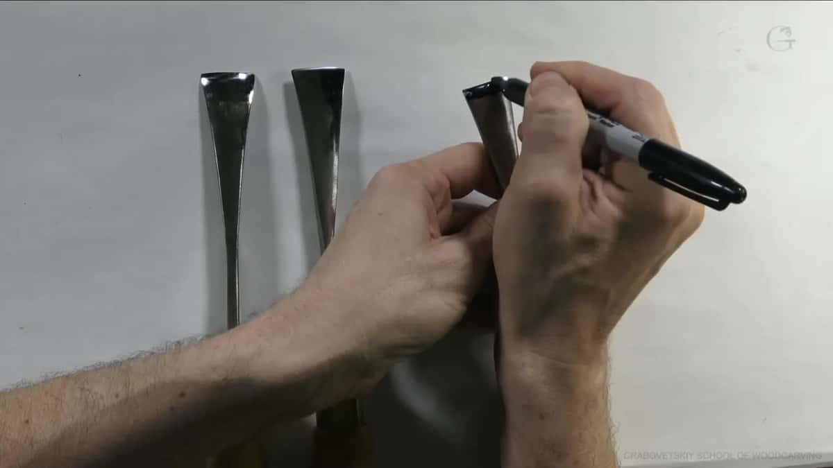 Sharpie tip touching the right-hand blade, close to its edge
