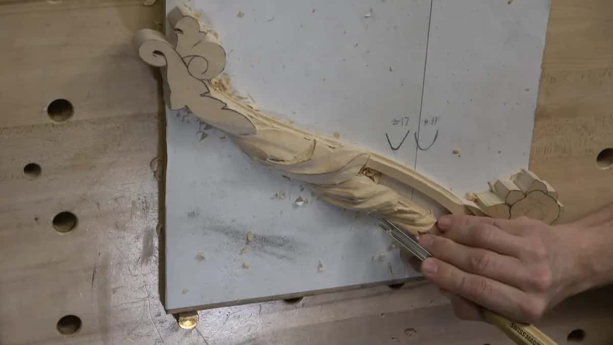 Gouge held low, two hands.