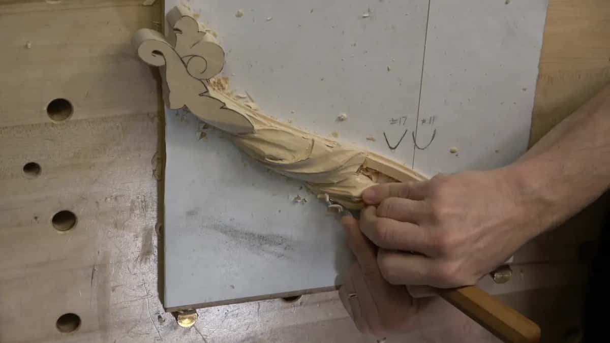 The long handle stays low while both hands work the middle of the leaf.