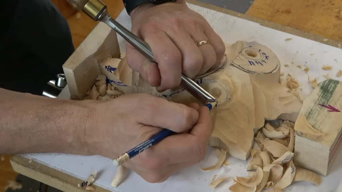 Gouge in one hand, pencil still in the other