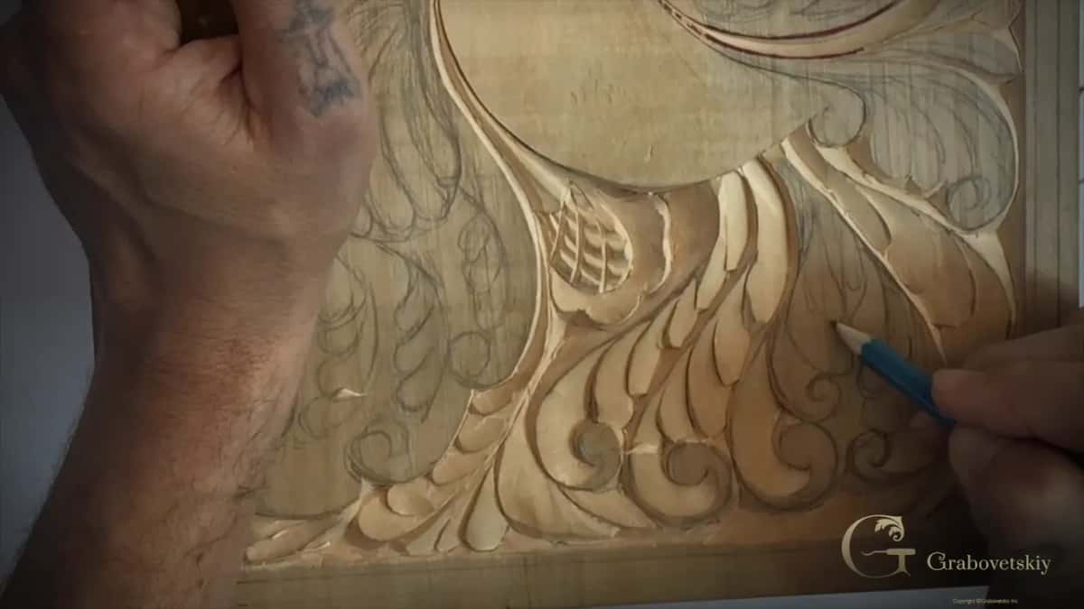 Blue pencil drawing on the tail while my other hand rests at the top of the board