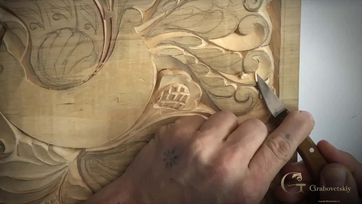 Knife point in a curl next to a crosshatched cone shape, fingers wrapped around the handle