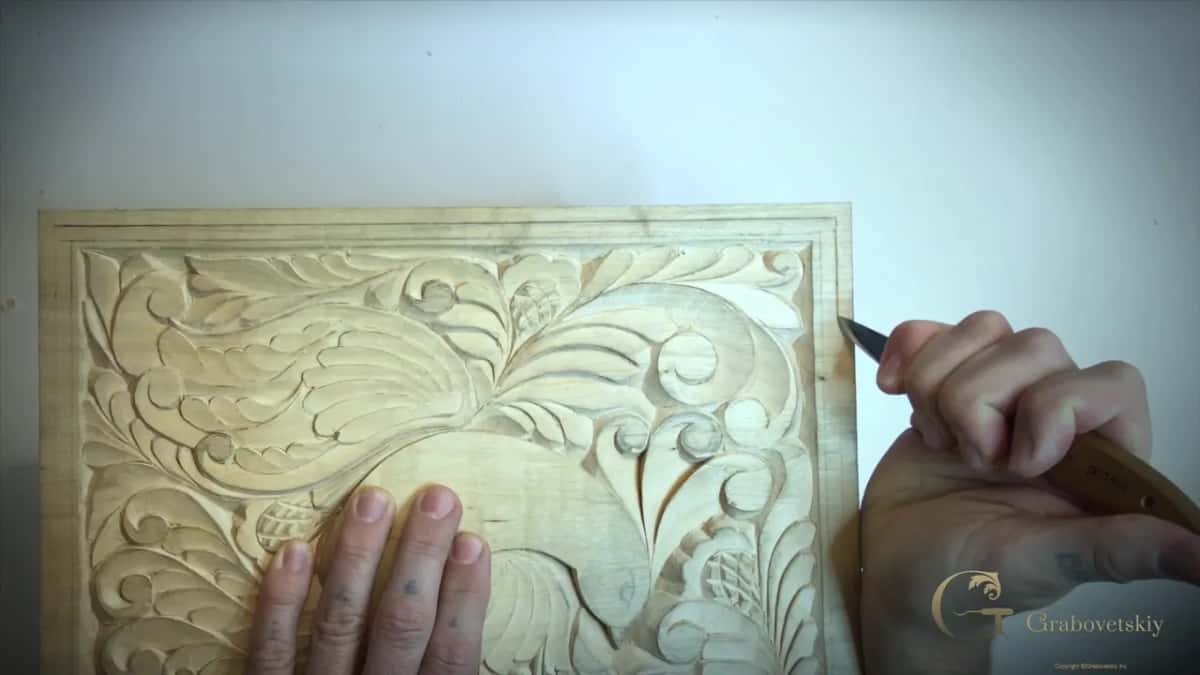 With the board turned sideways, the knife point rests at the right hand edge line