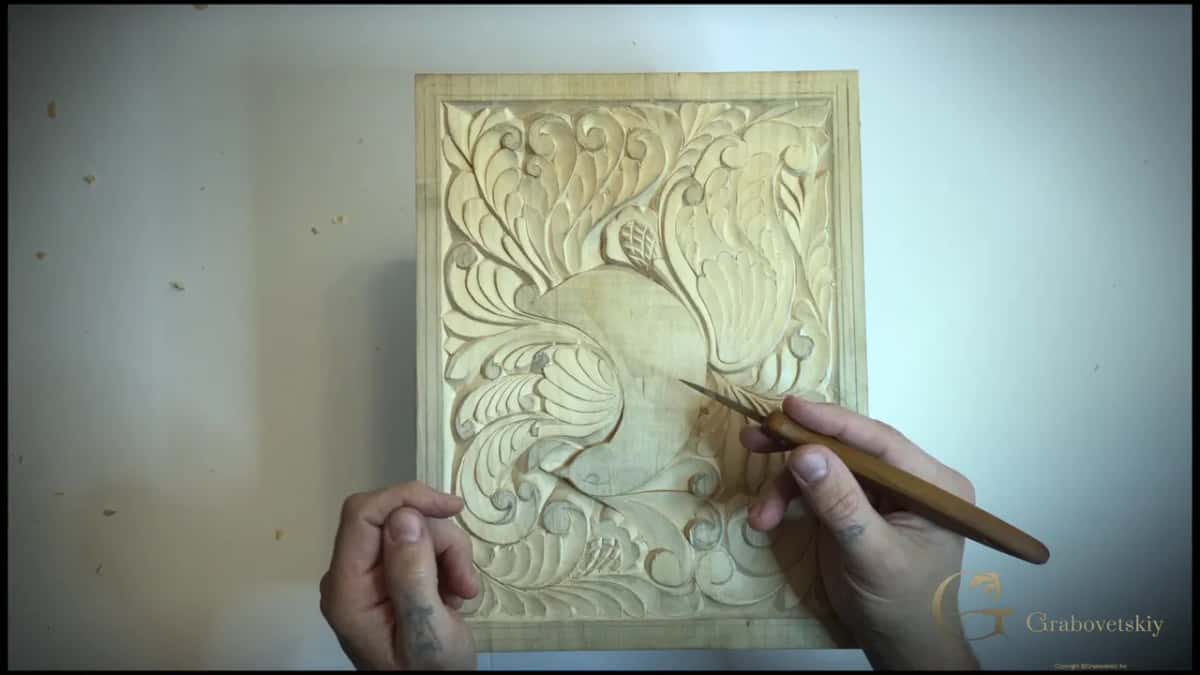Knife with a brown handle held over the bird panel, before any border