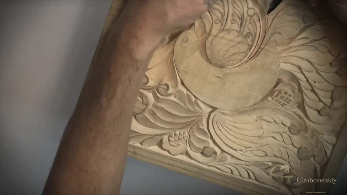 My arm reaching over the turned board to the top of the wing, where the knife works