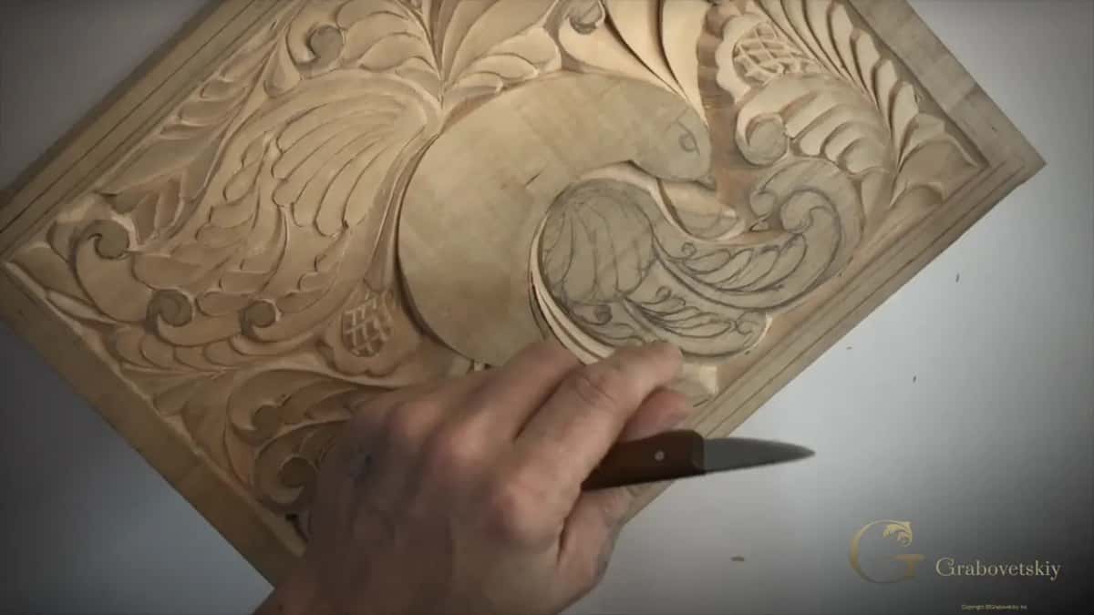 Knife lying in my hand below the wing that is still only pencil lines
