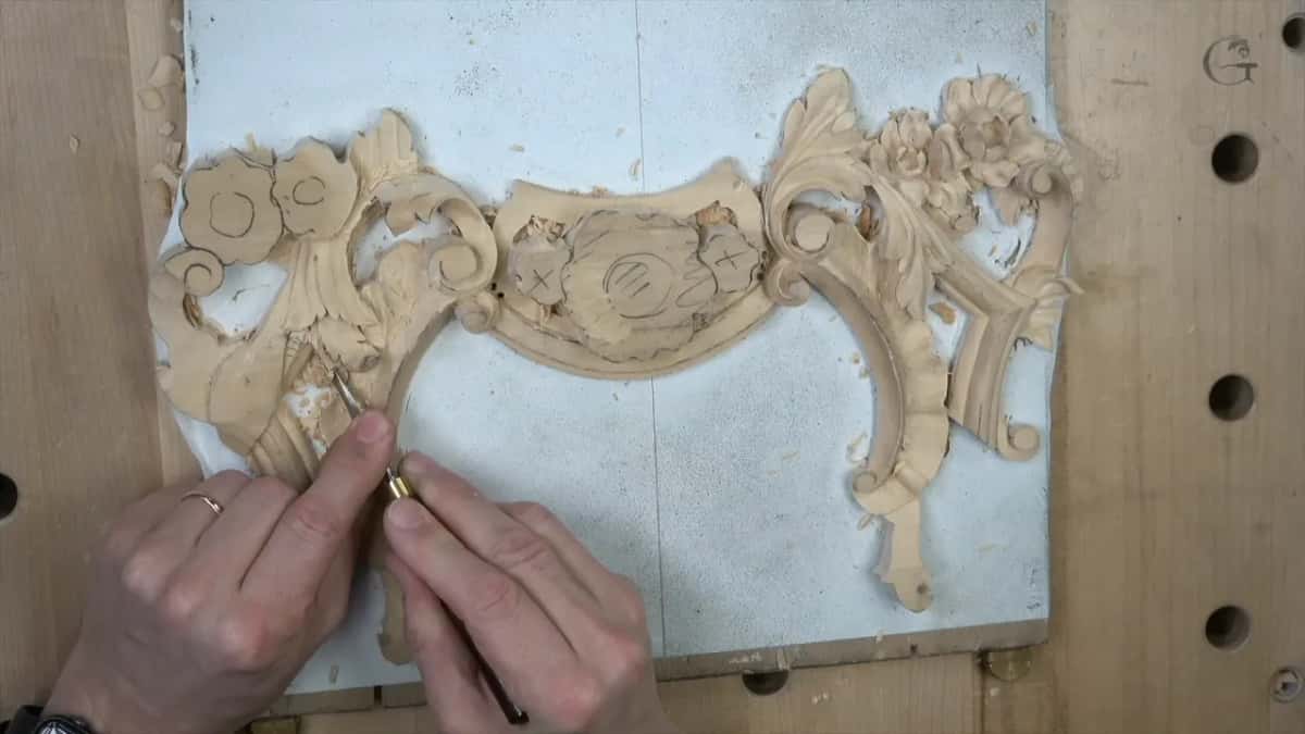 Hands guide a small tool down the left side of the leaf