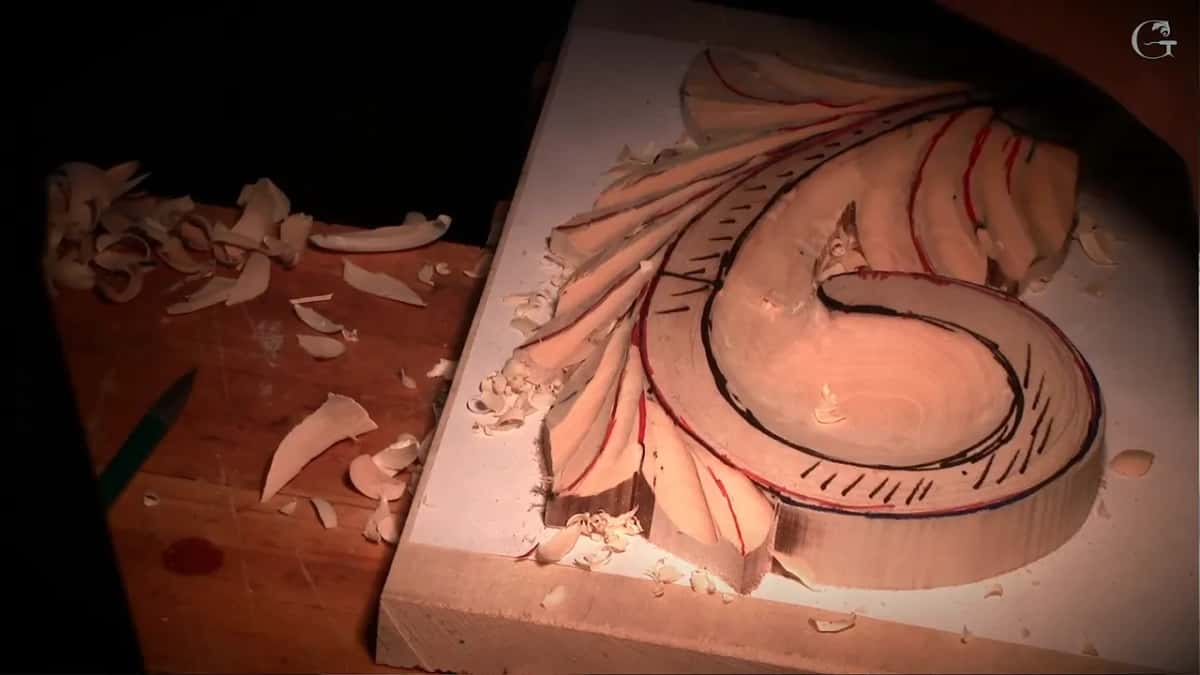 First layer on its backing board, the swirl marked in black and red, chips all around