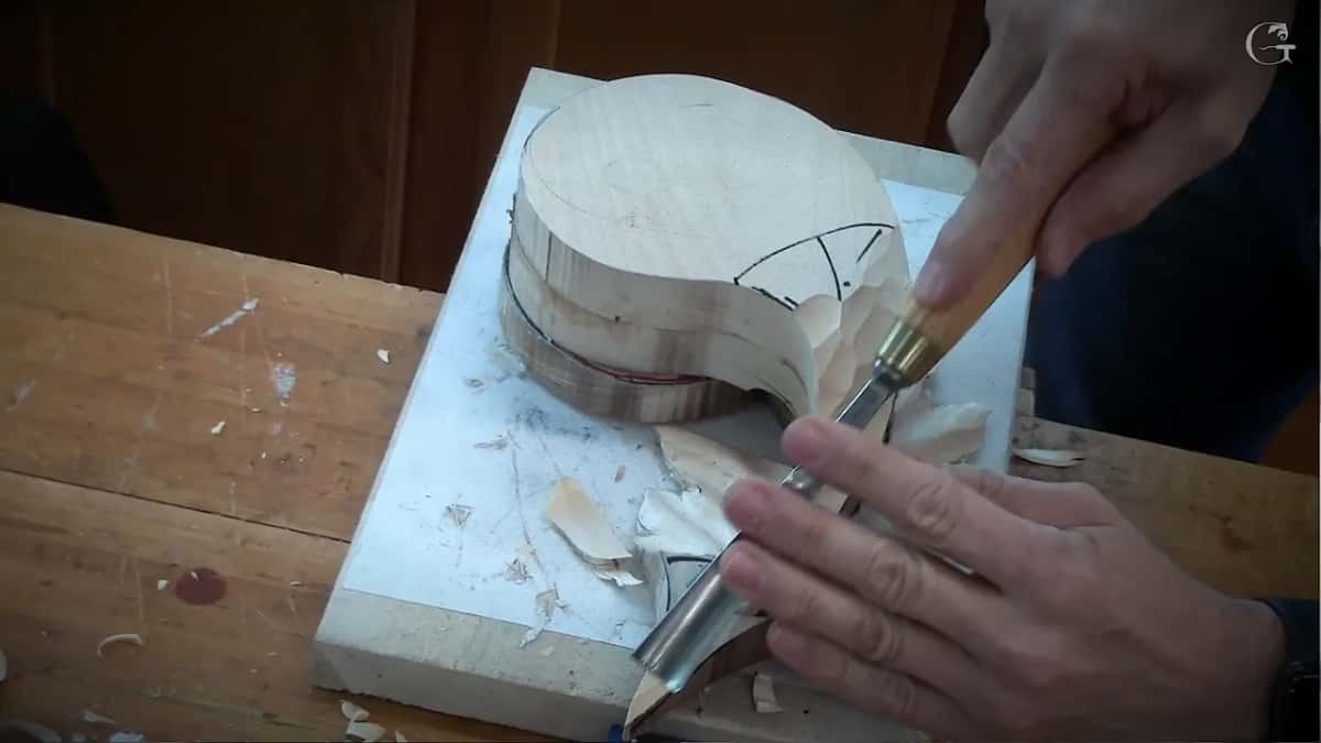 A gouge works down the edge of the stack