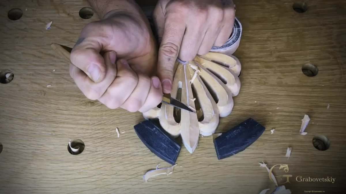 Fist around a knife, its edge in one leaf