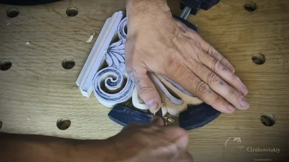 One hand flat over the leaves while the other works in from below, chips at the tips