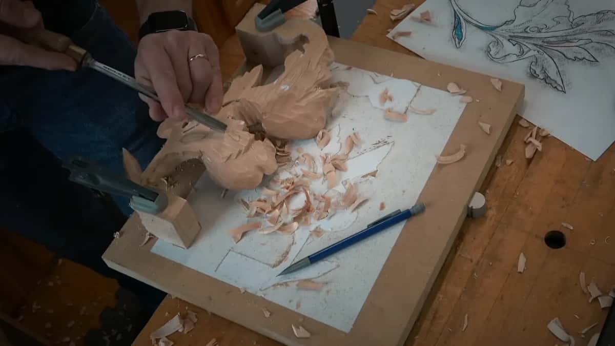 One hand on the gouge, the other steadying the carving