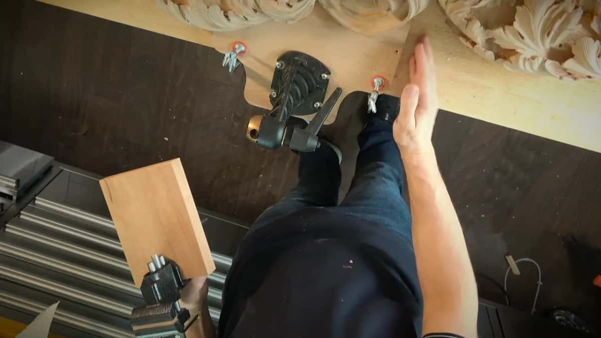 Clamps hold a carved panel and a small board, seen from above