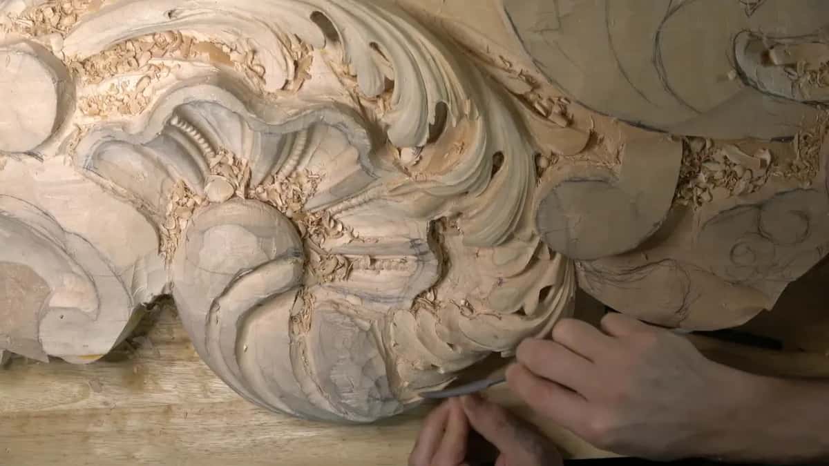 Fingers guiding a short tool along the lower edge