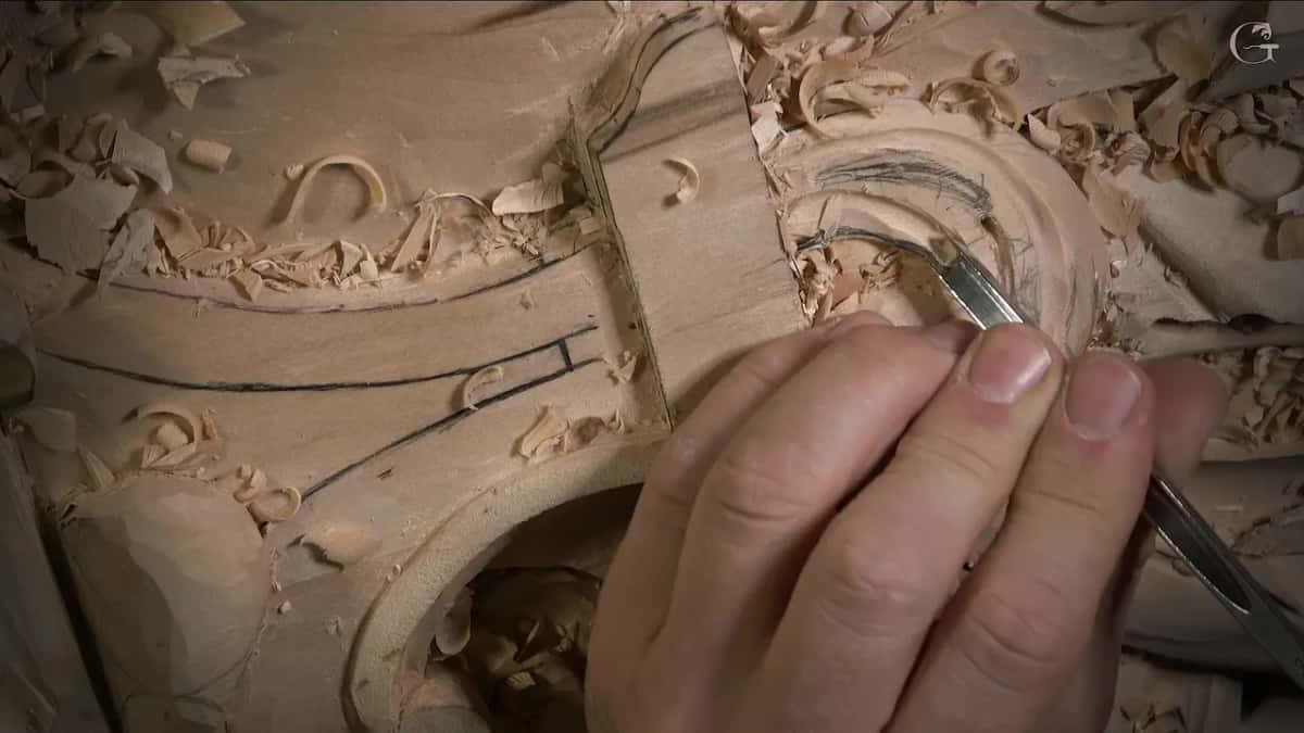 A slim gouge in my fingers, working a curved hollow beside two pencil lines