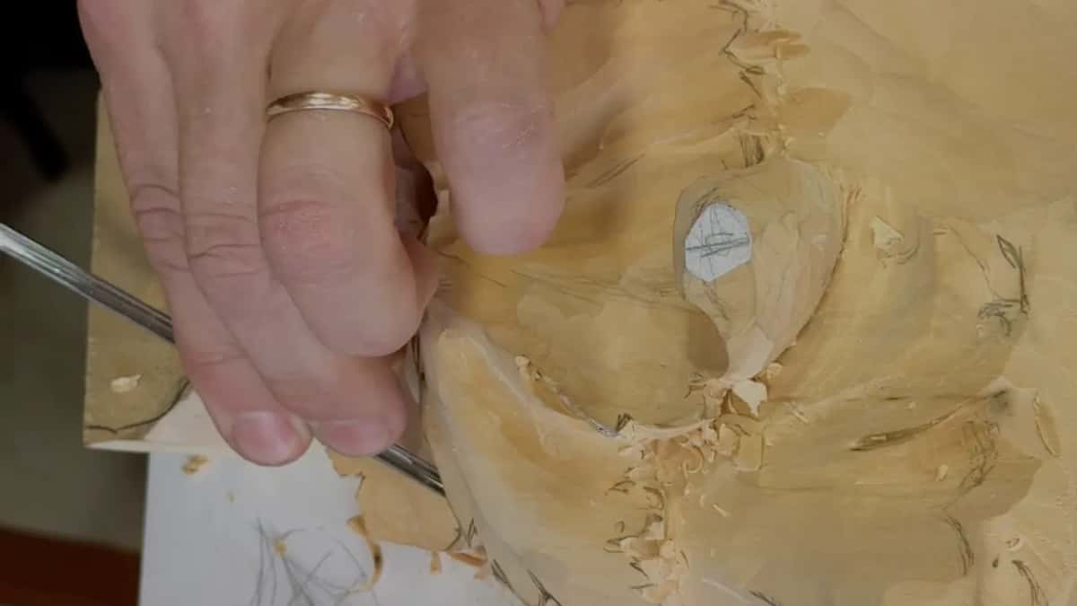 A ring hand steers a slim tool, most of it hidden under the fingers