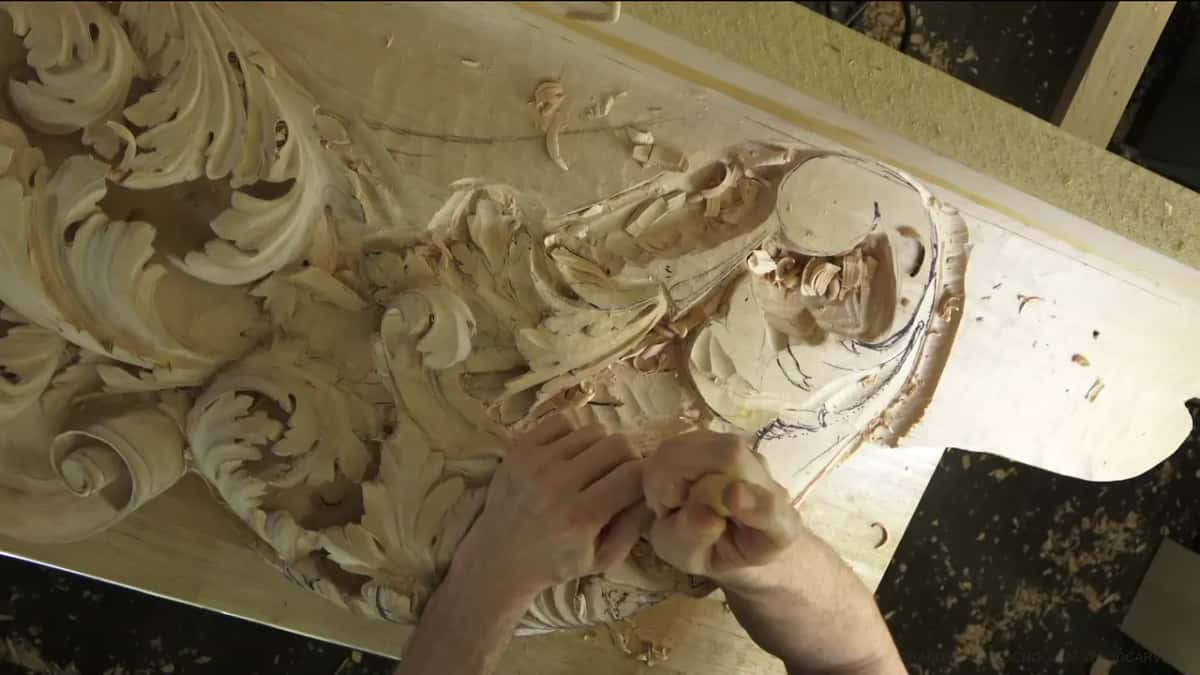 Big acanthus scrolls, hands low beside them