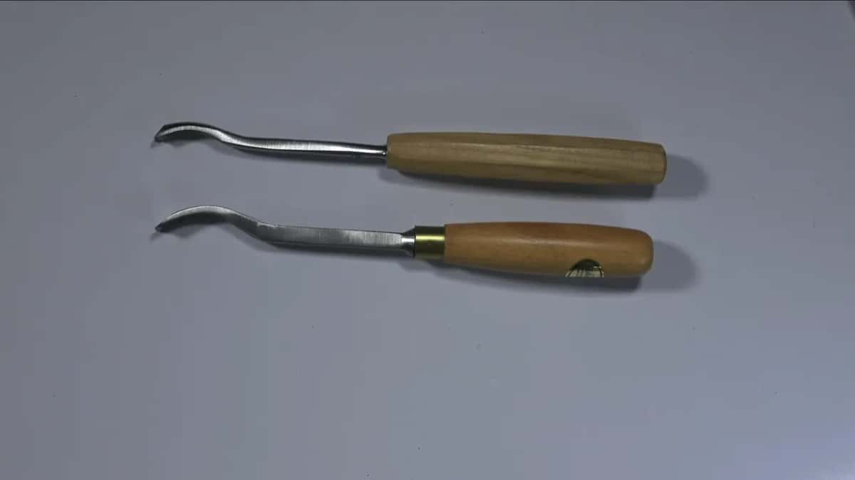 Two bent tools, the lower with a brass ring
