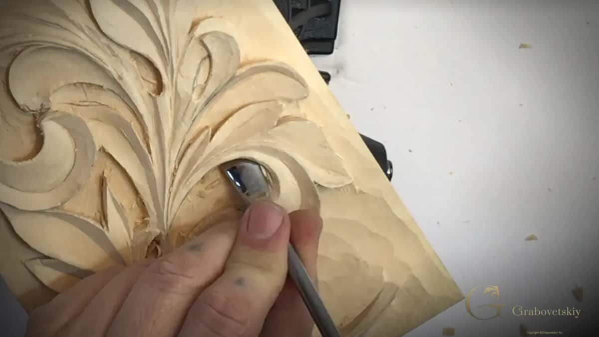 Back bend held under the rib of a curling Greek acanthus lobe