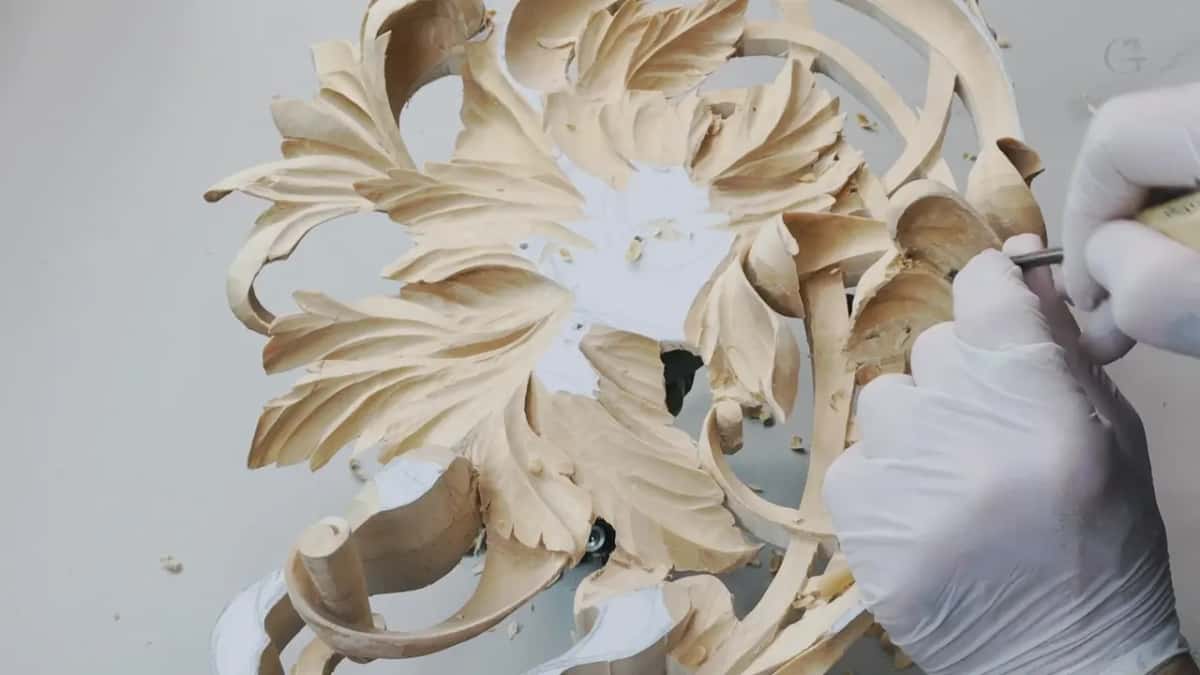 Gloved hands inside a pierced flower panel