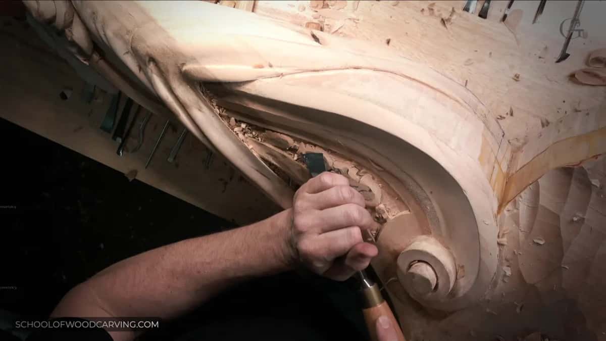 Driving a gouge along the channel above the scroll