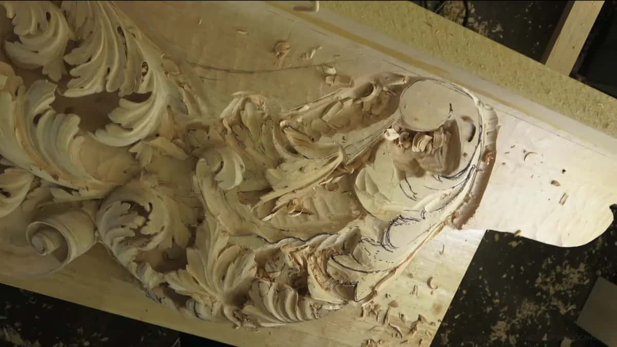 Acanthus scrolls carved deep into a big board, chips lying around them