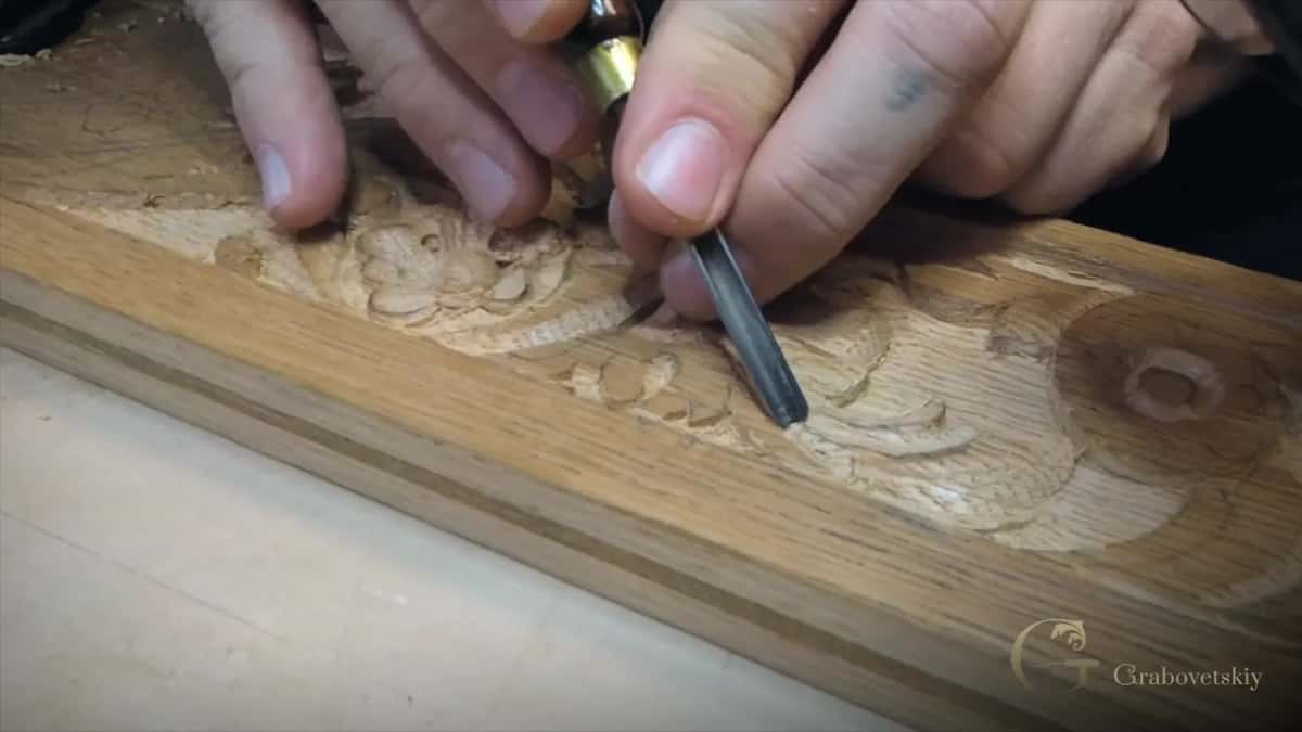 Fingertips guide a small gouge